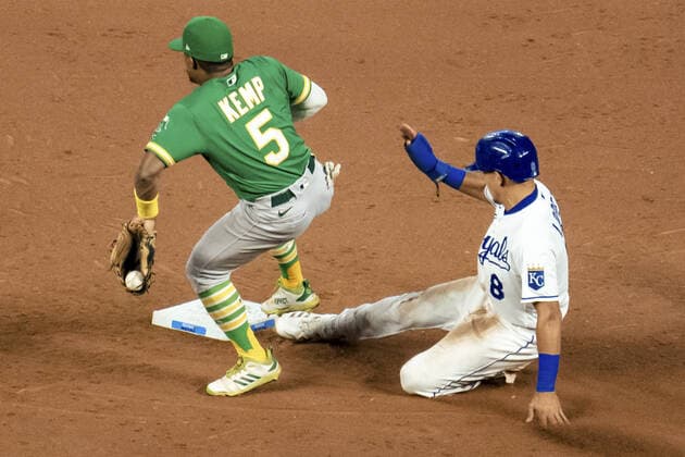 Kansas City Royals second baseman Nicky Lopez (8) slides safely past the tag from Oakland Athletics second baseman Tony Kemp (5) in the sixth inning at Kauffman Stadium in Kansas City, Missouri on Tuesday, September 14, 2021.  KCP20210914123 KYLExRIVAS