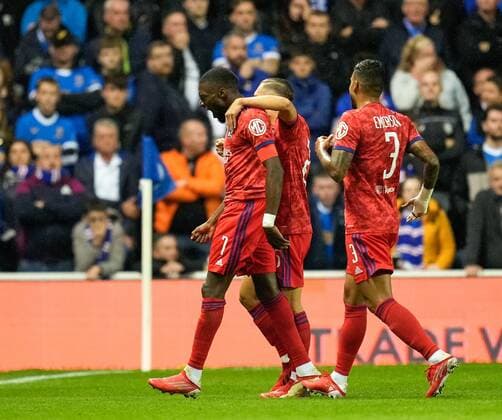 Mandatory Credit: Photo by Stuart Wallace Shutterstock (12447004x) Karl Toko Ekambi of Olympique Lyon celebrates with team mates Maxence Caqueret & Emerson Palmieri of Olympique Lyon after scoring to give Lyon a 0-1 lead. Rangers v Olympique Lyonnais, UEFA Europa League, Group A, Football, Ibrox Stadium, Glasgow, UK - 16 Sep 2021 EDITORIAL USE ONLY No use with unauthorised audio, video, data, fixture lists, club league logos or live services. Online in-match use limited to 120 images, no video emulation. No use in betting, games or single club league player publications. Rangers v Olympique Lyonnais, UEFA Europa League, Group A, Football, Ibrox Stadium, Glasgow, UK - 16 Sep 2021 EDITORIAL USE ONLY No use with unauthorised audio, video, data, fixture lists, club league logos or live services. Online in-match use limited to 120 images, no video emulation. No use in betting, games or single club league player publications. Copyright: xStuartxWallace Shutterstockx 12447004x