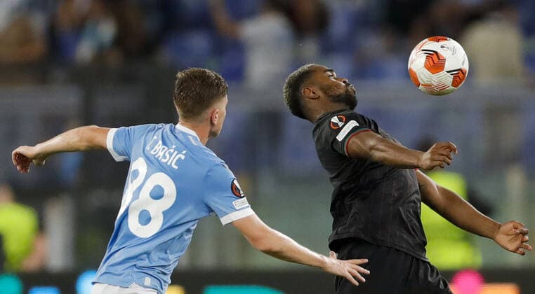 ROME, ITALY - SEPTEMBER 30, 2021: Lazio s Toma Basic (L) and Lokomotiv s Gyrano Kerk in action in the 2021 22 UEFA Europa League Group E Round 2 match between Lazio Rome and Lokomotiv Moscow at Stadio Olimpico. Mikhail Japaridze TASS  TS1128FF