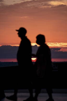 Fans walk the upper deck as the sun sets before the Kansas City Royals verse the Minnesota Twins game at Kaufman Stadium in Kansas City, Missouri on Friday, October 1, 2021.  KCP20211001101 KYLExRIVAS