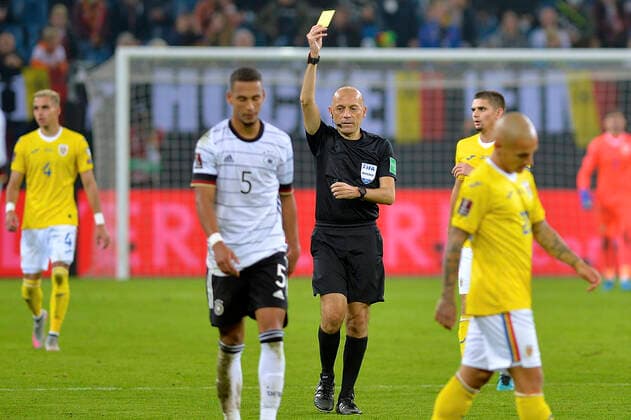 GERMANY - ROMANIA, European Qualifiers, 08 October 2021 Referee Cu?neyt C?akõr shows a yellow card during the 2022 FIFA World Cup, WM, Weltmeisterschaft, Fussball Qualifier match between Germany and Romania at Volksparkstadion on October 08, 2021 in Hamburg, Germany. Credit Photo: Alexandru Hojda Imago Images Copyright: xAlexandruxHojdax