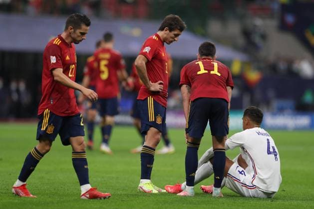 Milan, Italy, 10th October 2021. Pablo Sarabia of Spain walks by as team mates Mikel Oyarzabal and Ferran Torres look on as Raphael Varane of France waits for treatment before being substituted during the UEFA Nations League match at Stadio Giuseppe Meazza, Milan. Picture credit should read: Jonathan Moscrop Sportimage EDITORIAL USE ONLY. No use with unauthorised audio, video, data, fixture lists, club league logos or live services. Online in-match use limited to 120 images, no video emulation. No use in betting, games or single club league player publications. SPI-1236-0012
