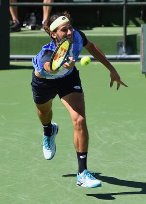 INDIAN WELLS, CA - OCTOBER 11: Lloyd Harris of South Africa dives to return a shot during a tennis match played at the BNP Paribas Open on October 11, 2021 at the Indian Wells Tennis Garden in Indian Wells, CA. (Photo by John Cordes Icon Sportswire) TENNIS: OCT 11 BNP Paribas Open Icon5061011035