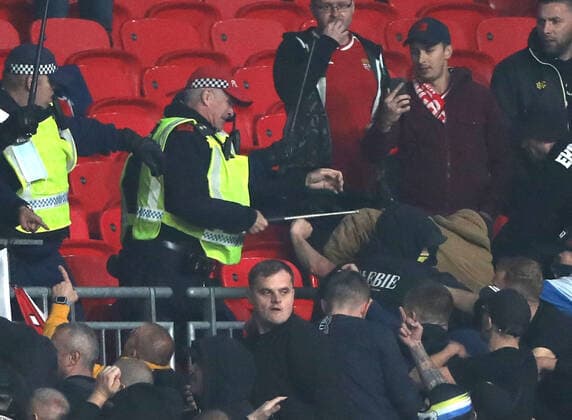 Police hit Hungary fans with batons at the England v Hungary World Cup Qualifier, at Wembley Stadium, London, UK on 12th October, 2021. 