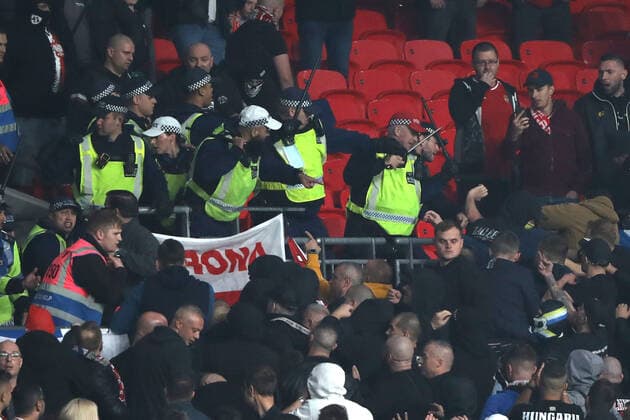 Police hit Hungary fans with batons at the England v Hungary World Cup Qualifier, at Wembley Stadium, London, UK on 12th October, 2021. 