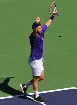 INDIAN WELLS, CA - OCTOBER 14: Cameron Norrie of Great Britain throws his arms in the air after defeating Diego Schwartzman of Argentina in straight sets of a quarterfinals tennis match played on October 14, 2021 at the BNP Paribas Open at the Indian Wells Tennis Garden in Indian Wells, CA. (Photo by John Cordes Icon Sportswire) TENNIS: OCT 14 BNP Paribas Open Icon506211014101