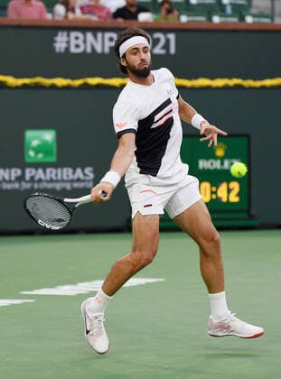 INDIAN WELLS, CA - OCTOBER 17: Nikoloz Basilashvili of Georgia returns the ball during a finals tennis match at the BNP Paribas Open played on October 17, 2021 at the Indian Wells Tennis Garden in Indian Wells, CA. (Photo by John Cordes Icon Sportswire) TENNIS: OCT 17 BNP Paribas Open Icon506211017901