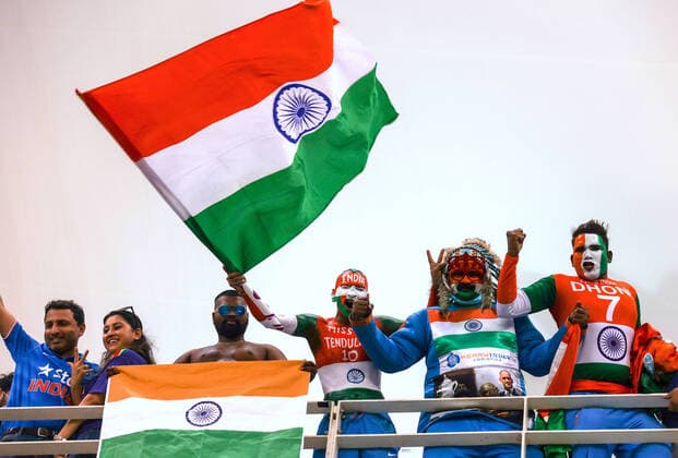 24th October 2021; Dubai International Cricket Stadium; Supporters of India wearing costumes yell and wave a national flag during the ICC Men s T20 World Cup match between India and Pakistan at Dubai International Cricket Stadium  ActionPlus12334161 DavidxGray
