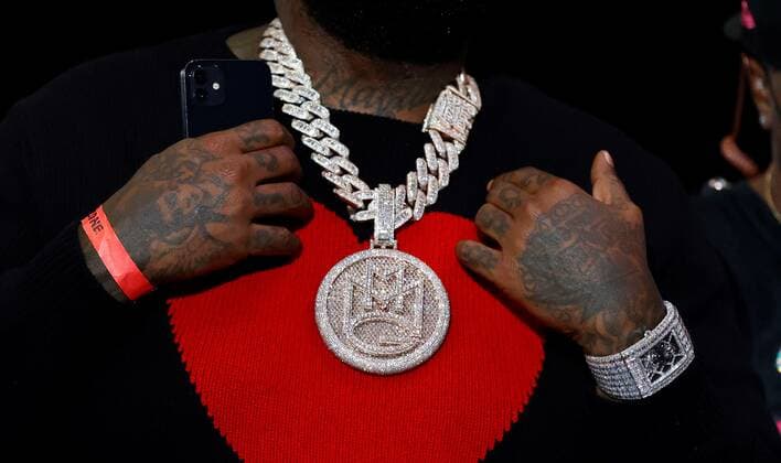 A detailed view of the necklace and watch worn by American Rapper Rick Ross during a timeout during the second half of the NBA, Basketball Herren, USA basketball game between the Miami Heat and the Boston Celtics, at FTX Arena in Miami, Florida, US, 04 November 2021. Boston Celtics at Miami Heat !ACHTUNG: NUR REDAKTIONELLE NUTZUNG!  Copyright: xRHONAxWISEx AME4778 20211105-6511ab412292f442c40071b2280c1cf8fafa8966