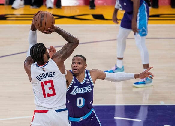 December 3, 2021, Los Angeles, California, USA: Paul George 13 of the Los Angeles Clippers puts up a shot over Russell Westbrook 0 of the Los Angeles Lakers during their regular season NBA, Basketball Herren, USA game on Friday December 3, 2021 at the Staples Center in Los Angeles, California. Lakers lose to Clippers, 115-119. PI Los Angeles USA - ZUMAp124 20211203_zaa_p124_040 Copyright: xJAVIERxROJASx