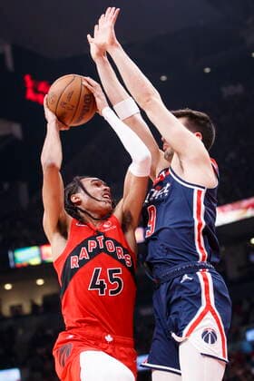 December 5, 2021, Toronto, ON, CANADA: Toronto Raptors guard Dalano Banton (45) goes to the basket against Washington Wizards forward Deni Avdija (9) during first half NBA, Basketball Herren, USA action in Toronto, Sunday, Dec. 5, 2021. Raptors Wizards NBA Action  - ZUMAc35_ 20211205_zaf_c35_164 Copyright: xColexBurstonx