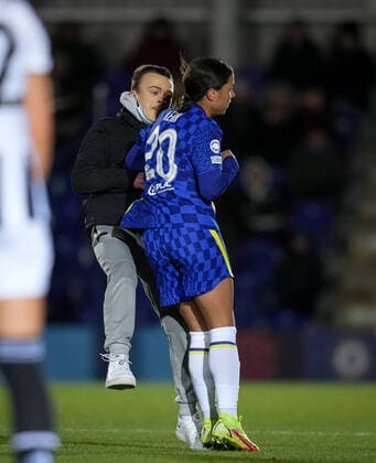 Sam Kerr of Chelsea shoulder barges a pitch invader during the UEFA Women s Champions League match between Chelsea Women and Juventus at the Kingsmeadow Stadium, Kingston, England on 8 December 2021. Copyright: xAndyxRowlandx PMI-4604-0017