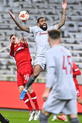 Antwerp s Pieter Gerkens and Olympiacos Yann M Vila fight for the ball during an Europa League game between Belgian soccer team Royal Antwerp FC and Greek soccer team Olympiacos F.C., Thursday 09 December 2021, in Antwerp, Belgium, on the sixth and last day in Group D of the UEFA Europa League group stage. LAURIExDIEFFEMBACQ  x3152754x