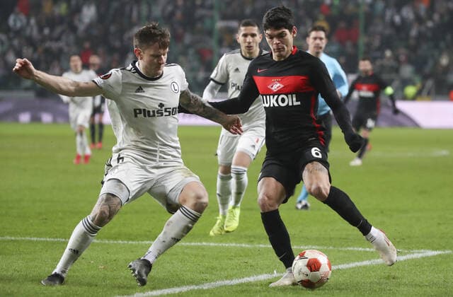 WARSAW, POLAND - DECEMBER 9, 2021: Legia s Mattias Johansson (L) and Spartak s Ayrton struggle for the ball in the 2021 22 UEFA Europa League Group C Round 6 match between Spartak Moscow and Legia Warsaw at the Marshall Jozef Pilsudski s Municipal Stadium of Legia Warsaw. Alexander Demianchuk TASS  TS11B4CB