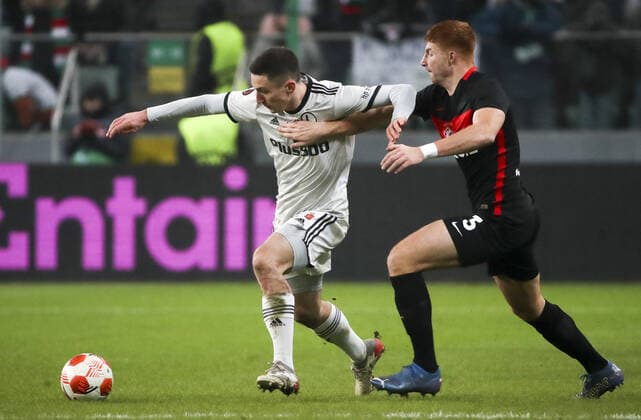 WARSAW, POLAND - DECEMBER 9, 2021: Legia s Lirim Kastrati (L) and Spartak s Maximiliano Caufriez struggle for the ball in the 2021 22 UEFA Europa League Group C Round 6 match between Spartak Moscow and Legia Warsaw at the Marshall Jozef Pilsudski s Municipal Stadium of Legia Warsaw. Alexander Demianchuk TASS  TS11B4CC