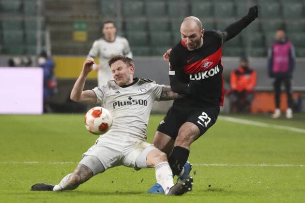 WARSAW, POLAND - DECEMBER 9, 2021: Legia s Mattias Johansson (L) and Spartak s Georgy Melkadze struggle for the ball in the 2021 22 UEFA Europa League Group C Round 6 match between Spartak Moscow and Legia Warsaw at the Marshall Jozef Pilsudski s Municipal Stadium of Legia Warsaw. Alexander Demianchuk TASS  TS11B4CE