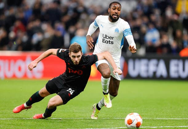 MARSEILLE, FRANCE - DECEMBER 9, 2021: Lokomotiv s Maxim Nenakhov (L) and Marseille s Gerson in action in the 2021 22 UEFA Europa League Group E Round 6 match between Olympique de Marseille and Lokomotiv Moscow at the Orange Velodrome Stadium. Mikhail Japaridze TASS  TS11B4E0