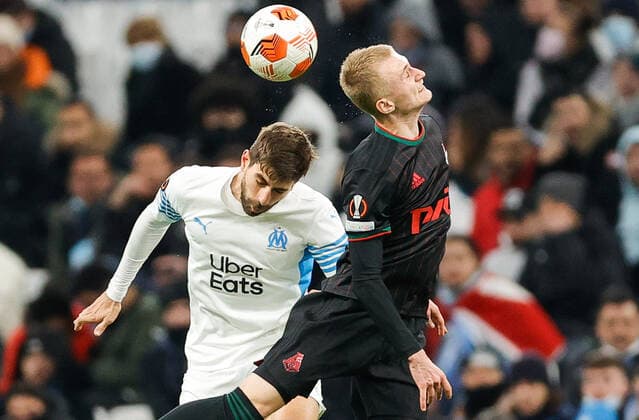 MARSEILLE, FRANCE - DECEMBER 9, 2021: Marseilleâ€™s Luan Peres (L) and Lokomotiv s Sergei Babkin in action in the 2021 22 UEFA Europa League Group E Round 6 match between Olympique de Marseille and Lokomotiv Moscow at the Orange Velodrome Stadium. Mikhail Japaridze TASS  TS11B4EE