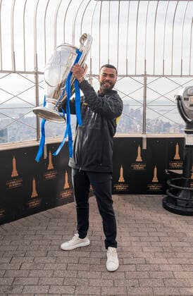 Chelsea FC legend Ashley Cole with Champions League Trophy at Empire State Building Chelsea FC legend Ashley Cole poses with Champions League Trophy at observation deck of the Empire State Building New York New York United States Copyright: LevxRadin