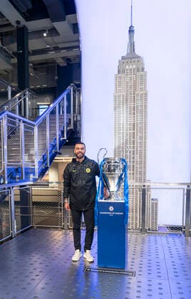 Chelsea FC legend Ashley Cole with Champions League Trophy at Empire State Building Chelsea FC legend Ashley Cole poses with Champions League Trophy on Grand Staircase of the Empire State Building New York New York United States Copyright: LevxRadin
