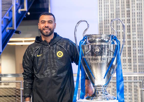 Chelsea FC legend Ashley Cole with Champions League Trophy at Empire State Building Chelsea FC legend Ashley Cole poses with Champions League Trophy on Grand Staircase of the Empire State Building New York New York United States Copyright: LevxRadin