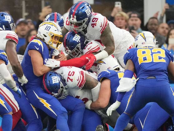 Sport Themen der Woche KW49 Sport Bilder des Tages Los Angeles Chargers quarterback Justin Herbert is tackled by New York Giants Danny Shelton (75) during second quarter action at SoFi Stadium on Sunday, December 12, 2021 in Inglewood, California. The Chargers defeated the Giants 37-21.  LAP20211212811 JONxSOOHOO
