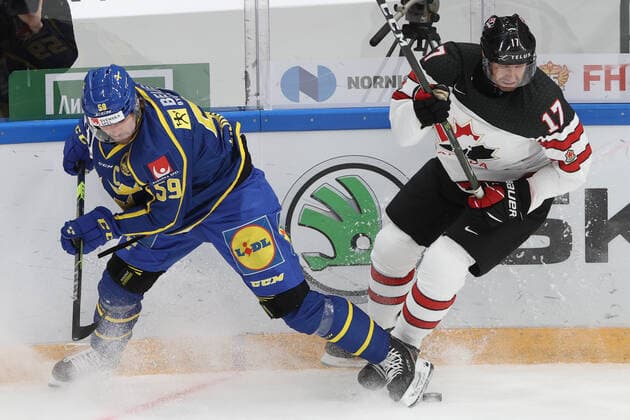 MOSCOW, RUSSIA â€“ DECEMBER 17, 2021: Swedenâ€™s Linus Johansson (L) and Canadaâ€™s Eric Fehr in their national teamsâ€™ 2021 Channel One Cup Ice hockey, Eishockey match at CSKA Arena as part of the 2021 22 Euro Hockey Tour. Valery Sharifulin TASS  TS11C2A7