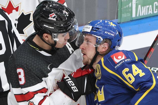 MOSCOW, RUSSIA â€“ DECEMBER 17, 2021: Canadaâ€™s John Gilmour (L) and Swedenâ€™s Jonathan Pudas fight during their national teamsâ€™ 2021 Channel One Cup Ice hockey, Eishockey match at CSKA Arena as part of the 2021 22 Euro Hockey Tour. Valery Sharifulin TASS  TS11C33A