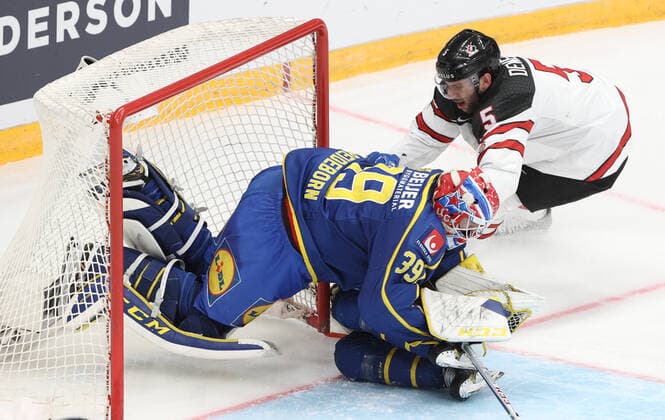 MOSCOW, RUSSIA â€“ DECEMBER 17, 2021: Swedenâ€™s goaltender Adam Reideborn (L) and Canadaâ€™s Jason Demers in their national teamsâ€™ 2021 Channel One Cup Ice hockey, Eishockey match at CSKA Arena as part of the 2021 22 Euro Hockey Tour. Valery Sharifulin TASS  TS11C33C