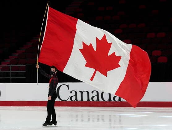 January 8, 2022, Ottawa, ON, Canada: Keegan Messing skates with a Canadian flag after a medal ceremony at the National Skating Championships, Saturday, Jan. 8, 2022 in Ottawa. Keegan Messing  - ZUMAc35_ 20220108_zaf_c35_156 Copyright: xAdrianxWyldx