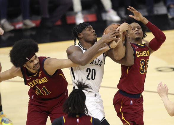 Brooklyn Nets Day Ron Sharpe (20) battles Cleveland Cavaliers Jarrett Allen (31) and Isaac Okoro (35) for a rebound at Rocket Mortgage Field House in Cleveland, Ohio on Monday, January 17, 2022.  CLE20220117108 AARONxJOSEFCZYK
