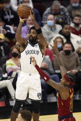 Brooklyn Nets Kyrie Irving (11) shoots over Cleveland Cavaliers Brandon Goodwin (26) at Rocket Mortgage Field House in Cleveland, Ohio on Monday, January 17, 2022.  CLE20220117112 AARONxJOSEFCZYK