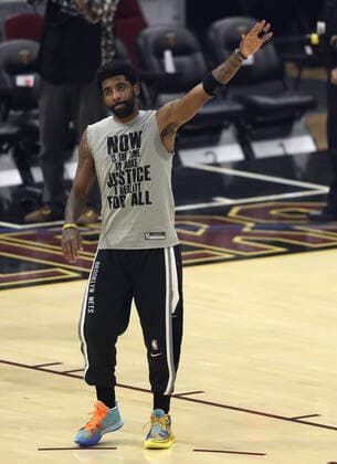 Brooklyn Nets Kyrie Irving (11) acknowledges the crowd after being introduced prior to the start against the Cleveland Cavaliers at Rocket Mortgage Field House in Cleveland, Ohio on Monday, January 17, 2022.  CLE20220117123 AARONxJOSEFCZYK