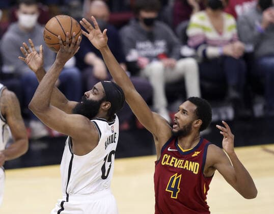 Brooklyn Nets James Harden (13) puts up a shot out of the reach of Cleveland Cavaliers Evan Mobley (4) at Rocket Mortgage Field House in Cleveland, Ohio on Monday, January 17, 2022.  CLE20220117128 AARONxJOSEFCZYK