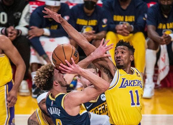 January 19, 2022, Los Angeles, California, USA: Malik Monk 11 of the Los Angeles Lakers tries to block a shot by Chris Duarte 3 of the Indiana Pacers during their NBA, Basketball Herren, USA game on Wednesday January 19, 2022 at Crypto.com Arena in Los Angeles, California. PI Los Angeles USA - ZUMAp124 20220119_zaa_p124_010 Copyright: xJAVIERxROJASx