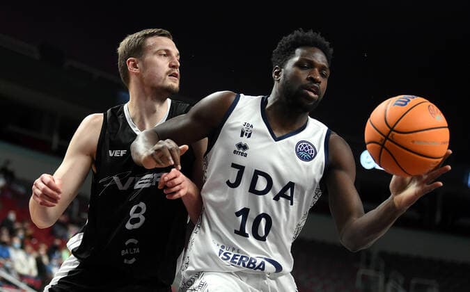 (220122) -- RIGA, Jan. 22, 2022 -- Anrijs Miska (L) of VEF Riga vies with Jacques Alingue of JDA Dijon Basket during the Europe Basketball Champions League Play-ins match between VEF Riga and JDA Dijon Basket in Riga, Latvia, Jan. 21, 2022. (Photo by Xinhua) (SP)LATVIA-RIGA-BASKETBALL-EUROPE CHAMPIONS LEAGUE-VEF RIGA VS JDA DIJON EdijsxPalens 