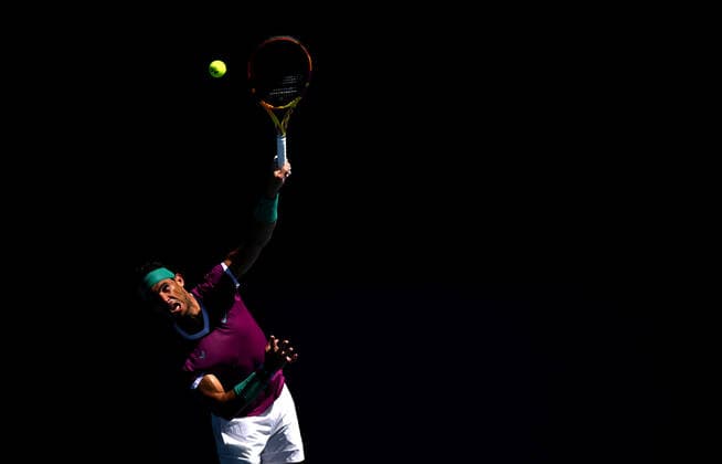 TENNIS AUSTRALIAN OPEN, Rafael Nadal of Spain in action serving during the 4th round match against Adrian Mannarino of France on Day 7 of the Australian Open at Melbourne Park in Melbourne, Sunday, January 23, 2022.( NO ARCHIVING, EDITORIAL USE ONLY, NO USE IN BOOKS WITHOUT CONSENT MELBOURNE VIC AUSTRALIA  Copyright: xDEANxLEWINSx 20220123001616113484