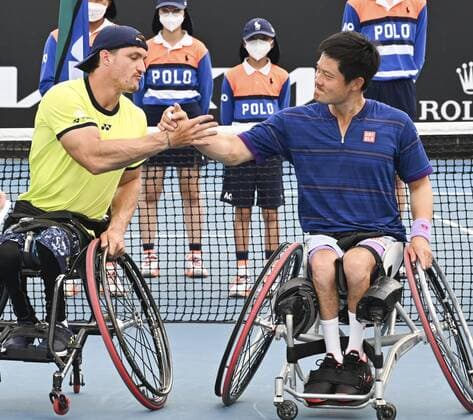 Tennis: Australian Open Shingo Kunieda (R) of Japan low-fives Gustavo Fernandez of Argentina after taking second place in the men s wheelchair doubles at the Australian Open tennis tournament in Melbourne on Jan. 26, 2022.  A14AA0001206585P