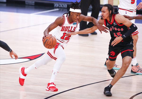 CHICAGO, IL - JANUARY 26: Chicago Bulls Guard Ayo Dosunmu (12) drives to the basket while being guarded by Toronto Raptors Guard Dalano Banton (45) during a NBA, Basketball Herren, USA game between the Toronto Raptors and the Chicago Bulls on January 26, 2022 at the United Center in Chicago, IL. (Photo by Melissa Tamez Icon Sportswire) NBA: JAN 26 Raptors at Bulls Icon22012606