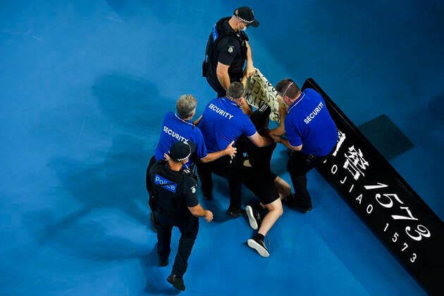 TENNIS AUSTRALIAN OPEN, Security remove a protester after invading the court during the men?s singles final between Rafael Nadal of Spain and Daniil Medvedev of Russia on Day 14 of the Australian Open at Melbourne Park in Melbourne, Sunday, January 30, 2022. ( NO ARCHIVING, EDITORIAL USE ONLY, NO USE IN BOOKS WITHOUT CONSENT MELBOURNE VIC AUSTRALIA  Copyright: xJAMESxROSSx 20220130001618411875