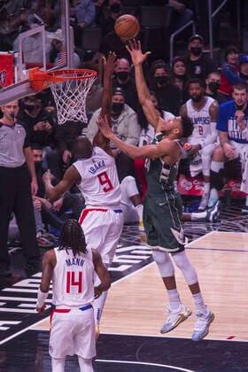 February 6, 2022, Los Angeles, California, USA: Giannis Antetokounmpo 34 of the Milwaukee Bucks scores as Serge Ibaka 9 of the Los Angeles Clippers attempts to block the shot during their NBA, Basketball Herren, USA game on Sunday February 6, 2022 at Crypto.com Arena in Los Angeles, California. Clippers lose to Bucks, 113-137. ARIANA RUIZ PI Los Angeles USA - ZUMAp124 20220206_zaa_p124_070 Copyright: xArianaxRuizx