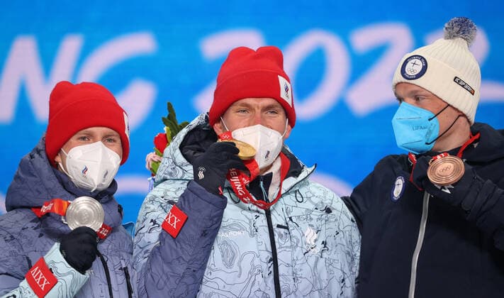ZHANGJIAKOU, CHINA - FEBRUARY 7, 2022: Athletes Denis Spitsov, Alexander Bolshunov of ROC and Iivo Niskanen (L-R) of Finland celebrates their respective medals during the men s 15km+15km skiathlon victory ceremony at the Medal Plaza as part of the 2022 Winter Olympic Games, Olympische Spiele, Olympia, OS Sergei Bobylev TASS  TS121C76