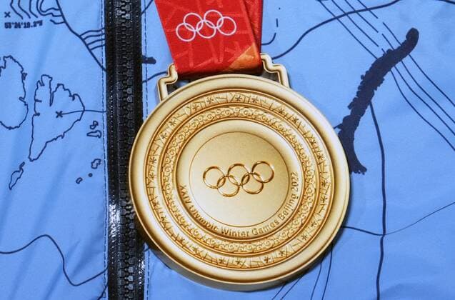 China Olympics 2022 Medal Ceremony 8107074 07.02.2022 The gold medal worn by Russian Olympic Committee s Alexander Bolshunov is pictured during the victory ceremony during for the men s cross-country skiathlon 2x15 km event of the Beijing 2022 Winter Olympic Games, Olympische Spiele, Olympia, OS at the Medal Plaza in Zhangjiakou, China. Pavel Bednyakov Sputnik Zhangjiakou China  Copyright: xPavelxBednyakovx