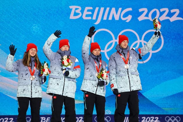 ZHANGJIAKOU, CHINA - FEBRUARY 8, 2022: Silver medallists Irma Makhinya, Danil Sadreyev, Irina Avvakumova and Yevgeny Klimov of Team ROC (L-R) wave during the victory ceremony for the mixed team normal hill (NH) final at the Medal Plaza at the 2022 Winter Olympic Games, Olympische Spiele, Olympia, OS Russian Olympic Committee TASS THIS IMAGE WAS PROVIDED BY A THIRD PARTY. EDITORIAL USE ONLY  TS121F79
