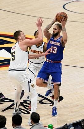 New York Knicks guard Evan Fournier 13, right, looks for an open man with pressure from Denver Nuggets center Nikola Jokic 15, center, as Denver Nuggets guard Monte Morris 11, left, looks on during the first quarter at the Ball Arena in Denver, CO, USA, 08 February 2022. EPA Todd Pierson Denver Nuggets - New York Knicks !ACHTUNG: NUR REDAKTIONELLE NUTZUNG!  Copyright: xToddxPiersonx AME4546 20220209-8a50a29a4685d319cd1cd36533bb6ff81dc990f6