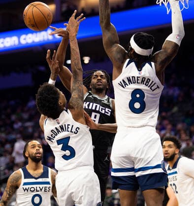 February 9, 2022, Sacramento, CA, USA: Sacramento Kings Justin Holiday pass ball around Minnesota Timberwolves forward Jaden McDaniels (3) and Minnesota Timberwolves forward Jarred Vanderbilt (8) in the second quarter during a game at Golden 1 Center on Wednesday, Feb. 9, 2022 in Sacramento. Sacramento USA - ZUMAj89_ 20220209_zaf_j89_015 Copyright: xPaulxKitagakixJr.x