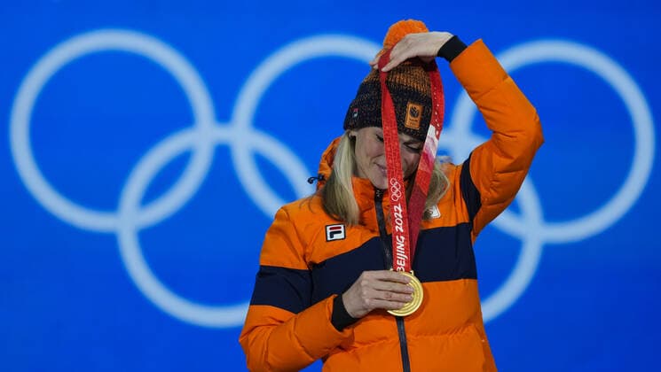 Irene Schouten of the Netherland s puts on her gold medal during a medals ceremony for the Women s Speed skating, Eisschnelllauf 5000m race at the Beijing 2022 Winter Olympics on Friday, February 11, 2022.  OLY20220211284 PaulxHanna