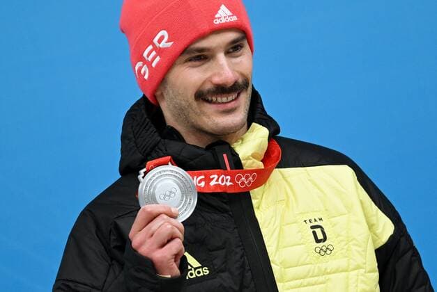 China Olympics 2022 Medal Ceremony 8111658 11.02.2022 Silver medalist Germany s Axel Jungk celebrates on the podium during the medal ceremony for the men s skeleton event of the Beijing 2022 Winter Olympic Games, Olympische Spiele, Olympia, OS at the National Sliding Centre in Yanqing, China. Vladimir Astapkovich Sputnik Yanqing China  Copyright: xVladimirxAstapkovichx