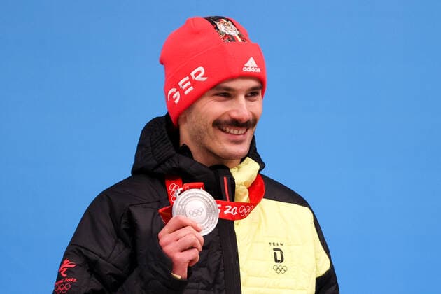 BEIJING, CHINA - FEBRUARY 11, 2022: Silver medalist, Axel Jungk of Germany poses for a photograph during an award ceremony for the men s skeleton event at the 2022 Winter Olympics at the Yanqing National Sliding Centre. Anton Novoderezhkin TASS  TS1228A2