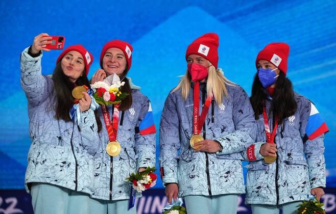 China Olympics 2022 Medal Ceremony 8112399 12.02.2022 Gold medalists Russian Olympic Committee s Yulia Stupak, Natalia Nepryaeva, Tatiana Sorina and Veronika Stepanova take a selfie during the medal ceremony for the women s cross-country 4x5 km relay event during the Beijing 2022 Winter Olympic Games, Olympische Spiele, Olympia, OS at the Medals Plaza in Zhangjiakou, China. Ramil Sitdikov Sputnik Beijing China  Copyright: xRamilxSitdikovx